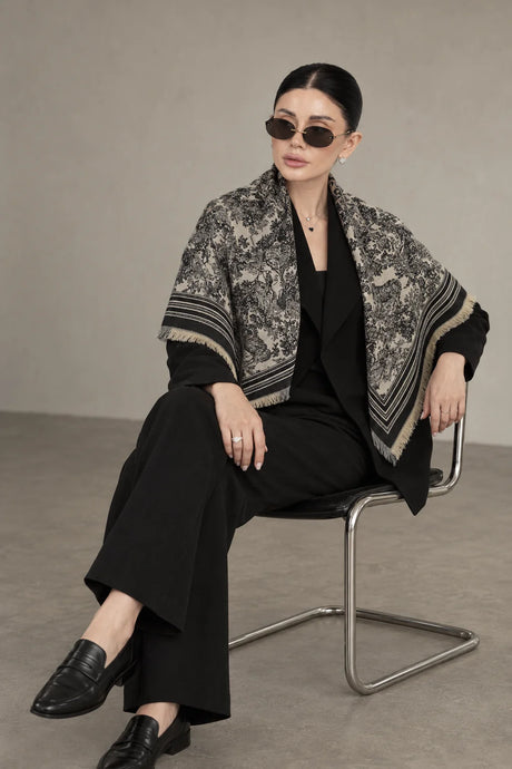 BLACK cashmere animal print square shawl folded into a triangle — seated