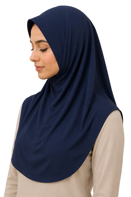 Woman wearing a navy hijab against a beige background